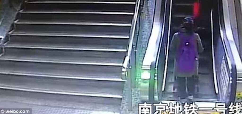 Mother and toddler take a tumble down on an escalator